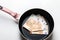 New frying pan with money euro banknotes isolated on a white background