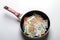 New frying pan with money euro banknotes isolated on a white background