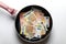 New frying pan with money euro banknotes isolated on a white background