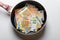 New frying pan with money euro banknotes isolated on a white background