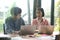 New generation of young men and women are sitting, consulting, working and using laptop on office desk