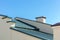 New gray corrugated metal roof against blue sky background