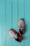 New gray textile sneakers over turquoise wooden floor