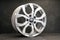 new grey alloy wheels on a dark textured black background. a wheel for a car toyota