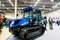 New Holland. tracked tractor performs work on slopes for gardens and vineyards