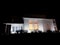 New House at Night with lights. Modern house with garage. Cozy warm light from window. Luxury house at dusk.