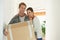 New house, portrait or happy couple with box for moving or excited for investment in real estate. Man, woman and proud