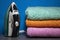 New Iron and Ironing Towels on the Table. Iron Irons linen. Pile of Clean Stacked Home Textile Items Near Blue Wall. Cozy House,
