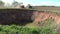 New karst sinkhole on agriculture farm field in North Lithuania and tractor