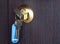 A new key in a keyhole in a wooden door