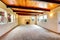 New large empty living room with wood ceiling and fireplace.