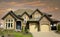 New Large Home House Beige Exterior Dramatic Cloudy Sky Background