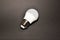 New led economy light bulb on black background