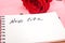 New life inscription in notepad paper page and red rose.