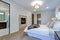 New luxury custom built home with white master bedroom.