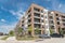 New luxury multistorey apartment community with parked cars near Dallas, Texas