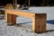 New massive benches in the woods on a lookout of larch wooden beams. screwed and fixed to the ground. sunken with snow. view from