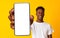 New mobile app ad. African american man showing white empty cellphone screen, recommending website or ad, mockup