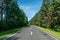 A new modern asphalt road passing through the forest. An empty country road in the woods. High-quality conditions for cargo and