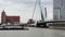 New Modern Boat passing under the Erasmus bridge over Nieuwe Maas in Rotterdam, Netherlands.