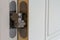 New modern metal door hinges on white wooden doors