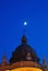 New moon shine over dome cupola in the evening clock table