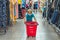 A new normal. Caucasian boy in sanitary face mask shopping in supermarket. Kid with buying basket. Child wearing