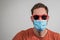New normal caucasian man wearing a covid coronavirus protective mask and red sunglasses. Cool male with sunshades and face mask