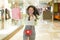 New normal habits - young attractive and happy Asian Chinese woman at shopping mall happy and excited enjoying sale in beauty