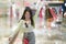 New normal habits - young attractive and happy Asian Japanese woman at shopping mall happy and excited enjoying sale in beauty