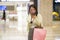 New normal habits - young attractive and happy Asian Korean woman using mobile phone at mall happy and excited enjoying sale in