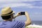 The new normal - middle-aged man takes a picture of the beach