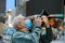 New normal tourism man in a mask takes pictures of New York travel city tour during summer holidays after lockdown