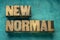 New normal word abstract in wood type