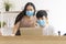 New normal work from home, health care, covid outbreak concept. Freelance young couple wear wearing face mask use laptop working