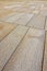 New paving made with stone blocks of rectangular shape in a pedestrian zone with wide joints for the drainage of rainwater