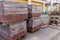 New paving slabs neatly stacked on pallets. Repair of sidewalks and replacement of paving slabs. Reconstruction of urban