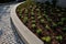 New plantings of perennials in the sloping park with anti-erosion battening. retaining walls cast from concrete in graceful arches