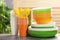 New plastic dishware on table against blurred background.