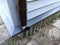 New plastic downpipe on an old house sheathed with new siding