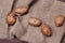 New potatoes on sackcloth on wooden table, top view