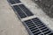 New rainwater grate on the road or sidewalk, installation in concrete. City sewage system for draining water during heavy rain