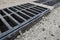 New rainwater grate on the road or sidewalk, installation in concrete. City sewage system for draining water during heavy rain