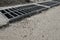 New rainwater grate on the road or sidewalk, installation in concrete. City sewage system for draining water during heavy rain