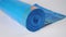 New Roll of blue garbage bags with orange strap on a white background