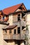 New roof tiles on top of brand new red bricks house with old abandoned wooden broken multi level house in front waiting to be