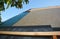 New roofing construction and asphalt shingles installation. A close-up of asphalt shingles installation on plywood, osb roof