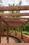 New round wooden pergola with long bench