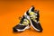 New running or unbranded running shoes on orange background. Men's sports shoes. A pair of sports shoes. Sport.