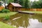 New rural bathhouse and pond with plank footbridge